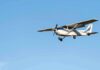 Single-engine airplane flying against clear blue sky