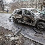 burned-out car with severe damage on a city street