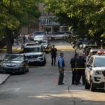 Active Shooter Chaos Stuns Downtown Police officers secure a residential street with patrol cars and yellow tape