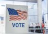 Voting booth with American flag design in a modern polling place