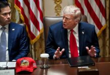 Donald Trump speaks at a meeting table beside Marco Rubio