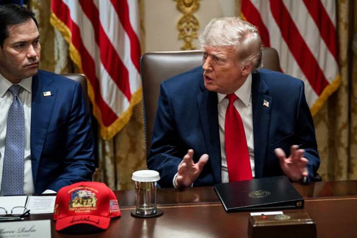 Donald Trump speaks at a meeting table beside Marco Rubio