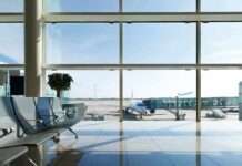 UAE Slams Iran Skies Shut Airport terminal with plane at gate viewed through large windows