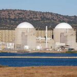 Kuwait Blames Iran For Water Strikes Nuclear power plant with domed structures beside a water body and mountains in the background