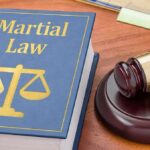 Law book with scales symbol beside a judge's gavel on a desk