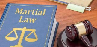 Law book with scales symbol beside a judge's gavel on a desk