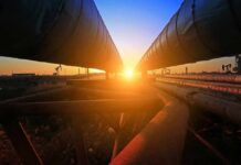 Industrial pipelines at sunset