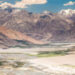 Glacier Collapse Sparks Deadly Chain Mountain valley with river and snow-capped peaks