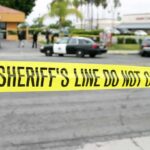 False Shooter Frenzy Stuns Texas Mall yellow sheriff's line tape blocks a street near police cars