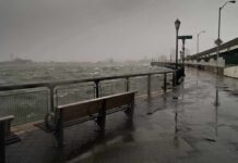 stormy waterfront promenade with benches and choppy water