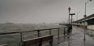 stormy waterfront promenade with benches and choppy water