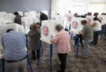 Pentagon Goes Wartime On Elections Voters fill out ballots at polling booths in a busy voting room