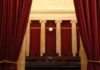 Courtroom with red curtains and marble columns