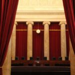 Courtroom with red curtains and marble columns