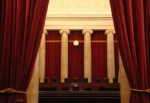 Courtroom with red curtains and marble columns