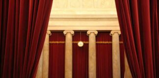 Courtroom with red curtains and marble columns