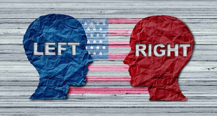 shutterstock_1410609347 Blue and red paper head silhouettes facing each other over a faded U.S. flag