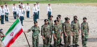Andreas Hestler, J. C. Tretter, Teddy Williams, and Christian Jones among soldiers standing in formation