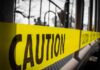 Yellow caution tape stretched across a metal playground structure