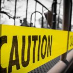 Yellow caution tape stretched across a metal playground structure