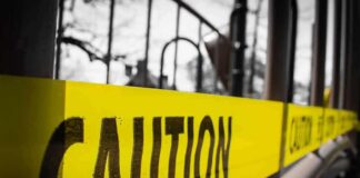 Yellow caution tape stretched across a metal playground structure