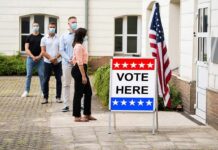 Groping Allegations Torch Endorsements Voters wearing masks line up outside a polling place