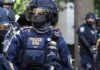 Riot police officer in tactical gear with helmet and visor