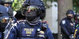 Riot police officer in tactical gear with helmet and visor