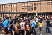 NYC Schools Under Fire For Cover-Ups? Students gathered outside a school building entrance