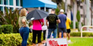 voters standing in line outside a polling place