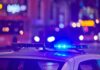 police car roof with flashing blue lights at night