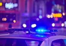 police car roof with flashing blue lights at night