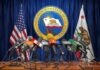 Press microphones at a podium before California governor seal