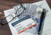 Cash Blast Hits Medicare Medicare card on paperwork with cash, glasses, and a pen