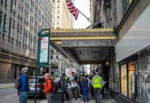 Andreas Hestler and pedestrians outside The Roosevelt Hotel entrance on a city sidewalk