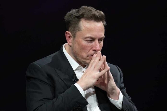 shutterstock_2318800313 Elon Musk seated with hands steepled in thought