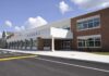 Sub Teacher Arrested After Shocking Kick Modern school building with large windows and a clear sky
