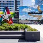 Mall entrance with colorful star sculpture and mirrored facade