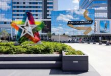 Mall entrance with colorful star sculpture and mirrored facade