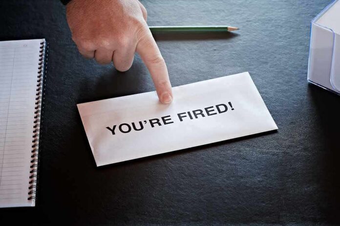 Hand pointing at a termination letter on a desk